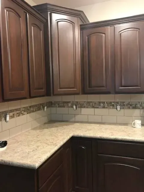 A kitchen with wooden cabinets and granite counter tops.