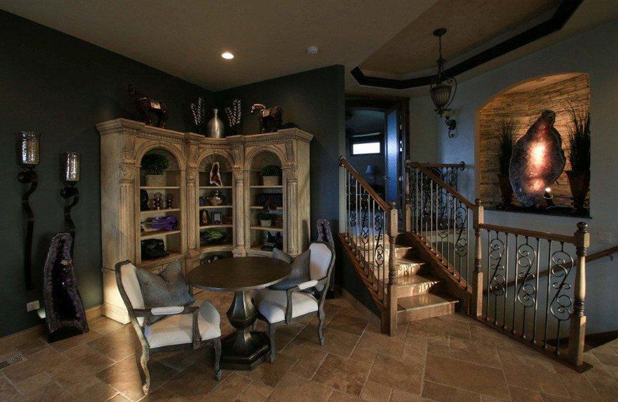 A living room with a table and chairs and stairs.