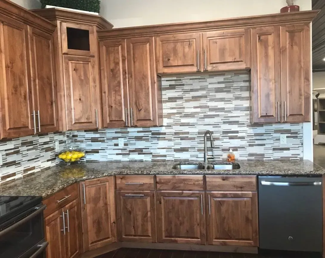 A kitchen with wooden cabinets and granite counter tops