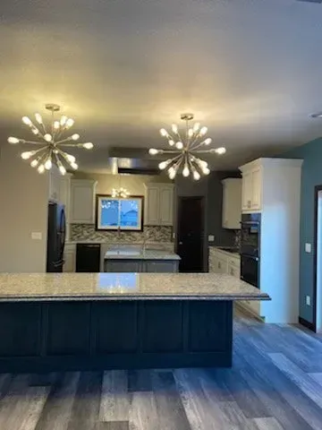 There is a large island in the middle of the kitchen.