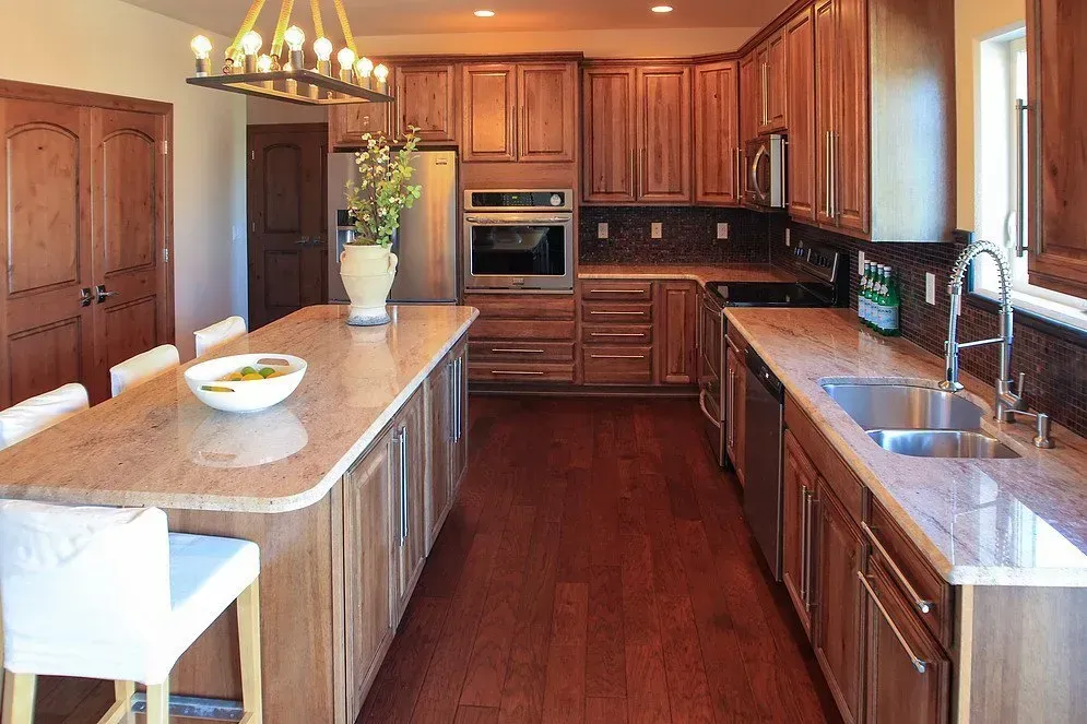 A kitchen with wooden cabinets and granite counter tops