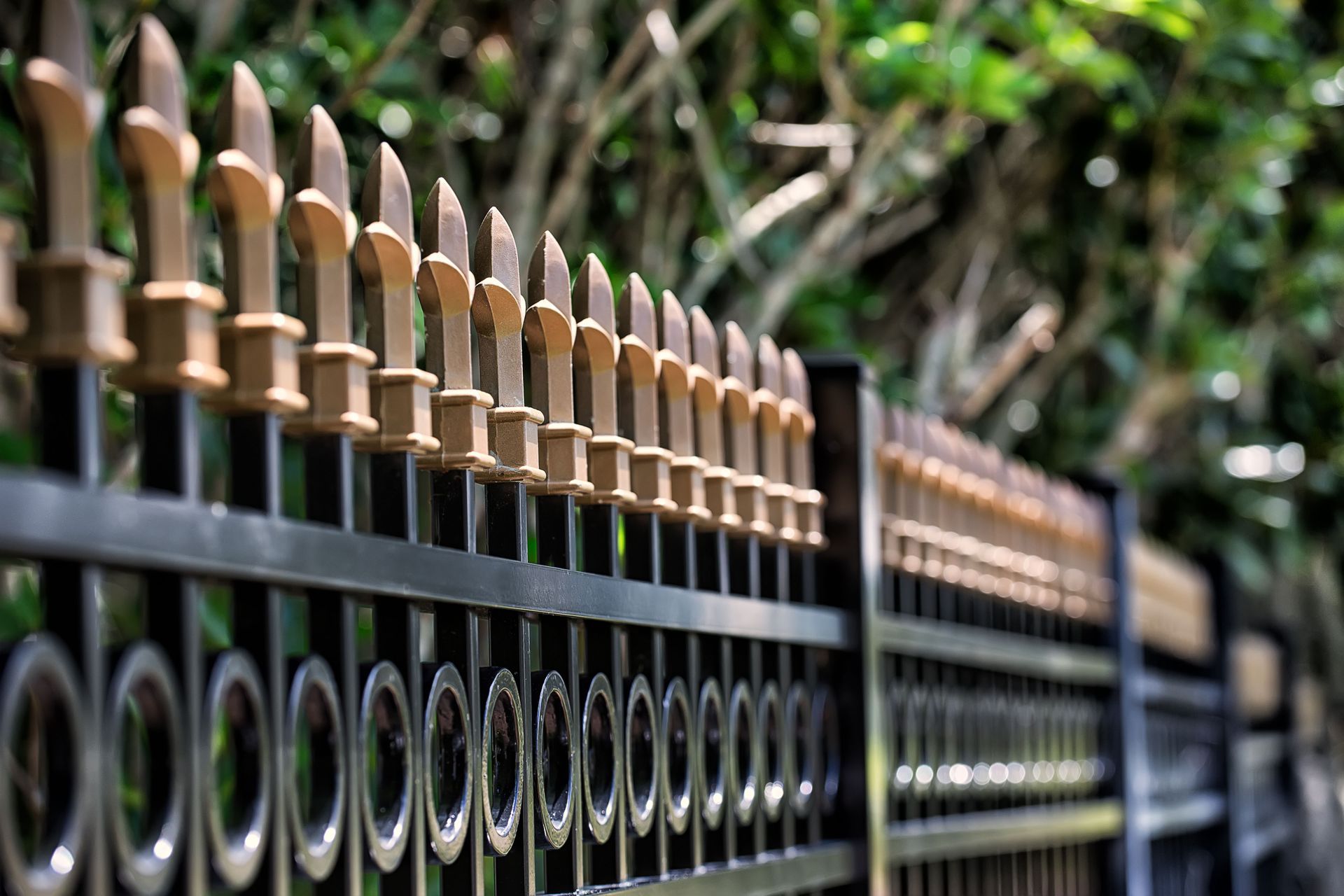 White picket fence along a beige house with a curved design.
