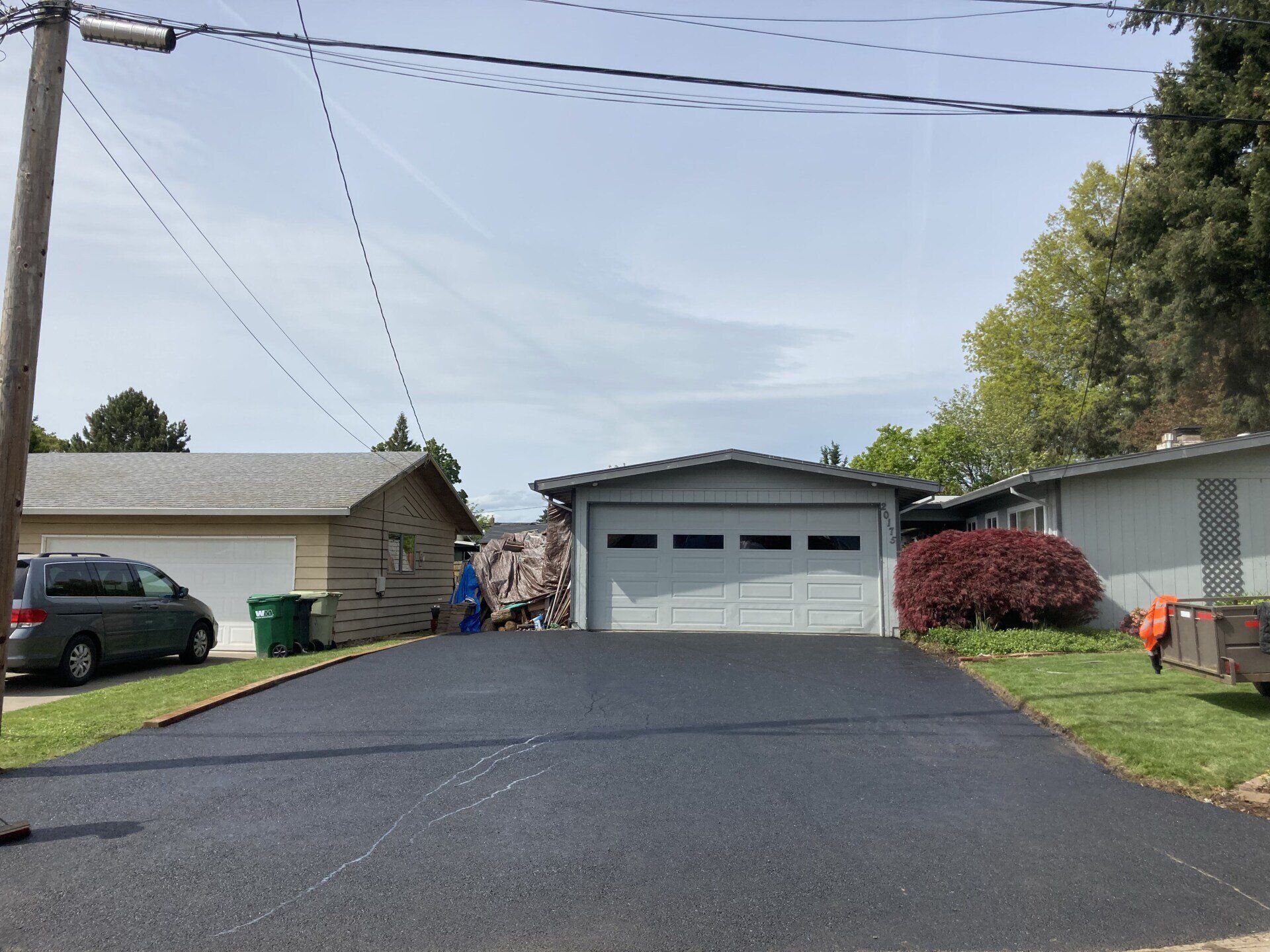 A driveway leading to a house with a garage