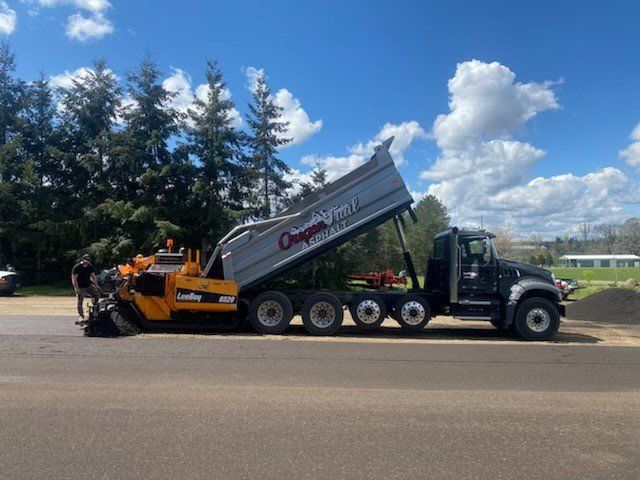 A dump truck is parked on the side of the road.