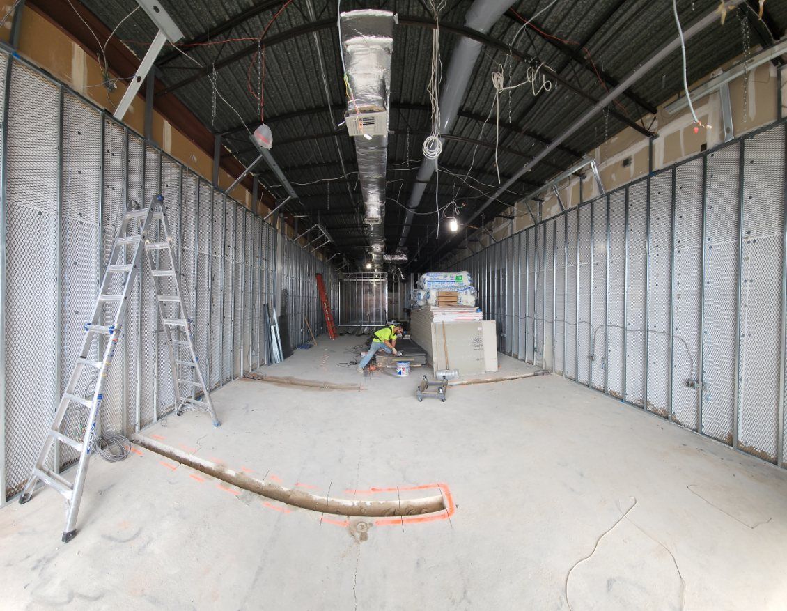 A large room with a ladder in the middle of it.