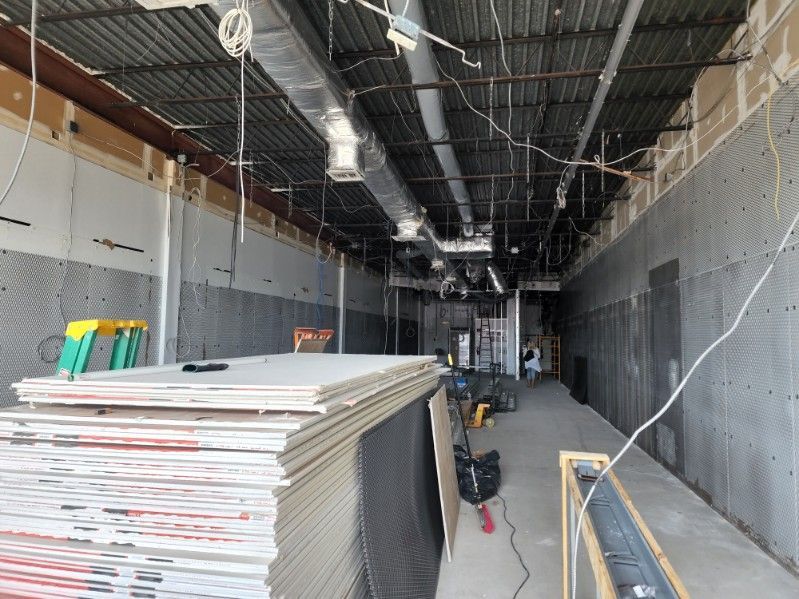 A stack of drywall is sitting in the middle of a building under construction.