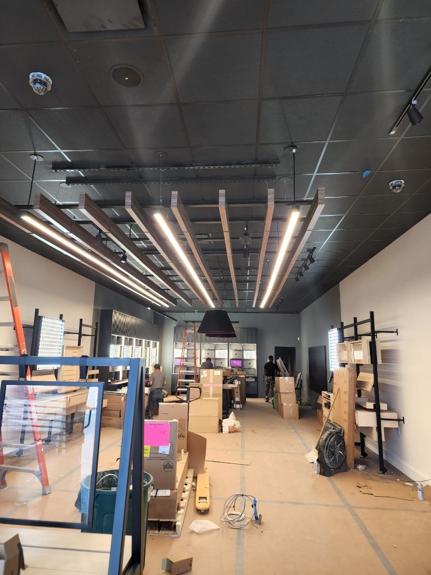 A large room with a black ceiling and a lot of boxes on the floor