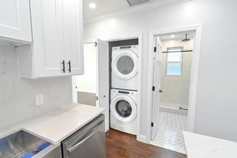 A laundry room with a washer and dryer stacked on top of each other.