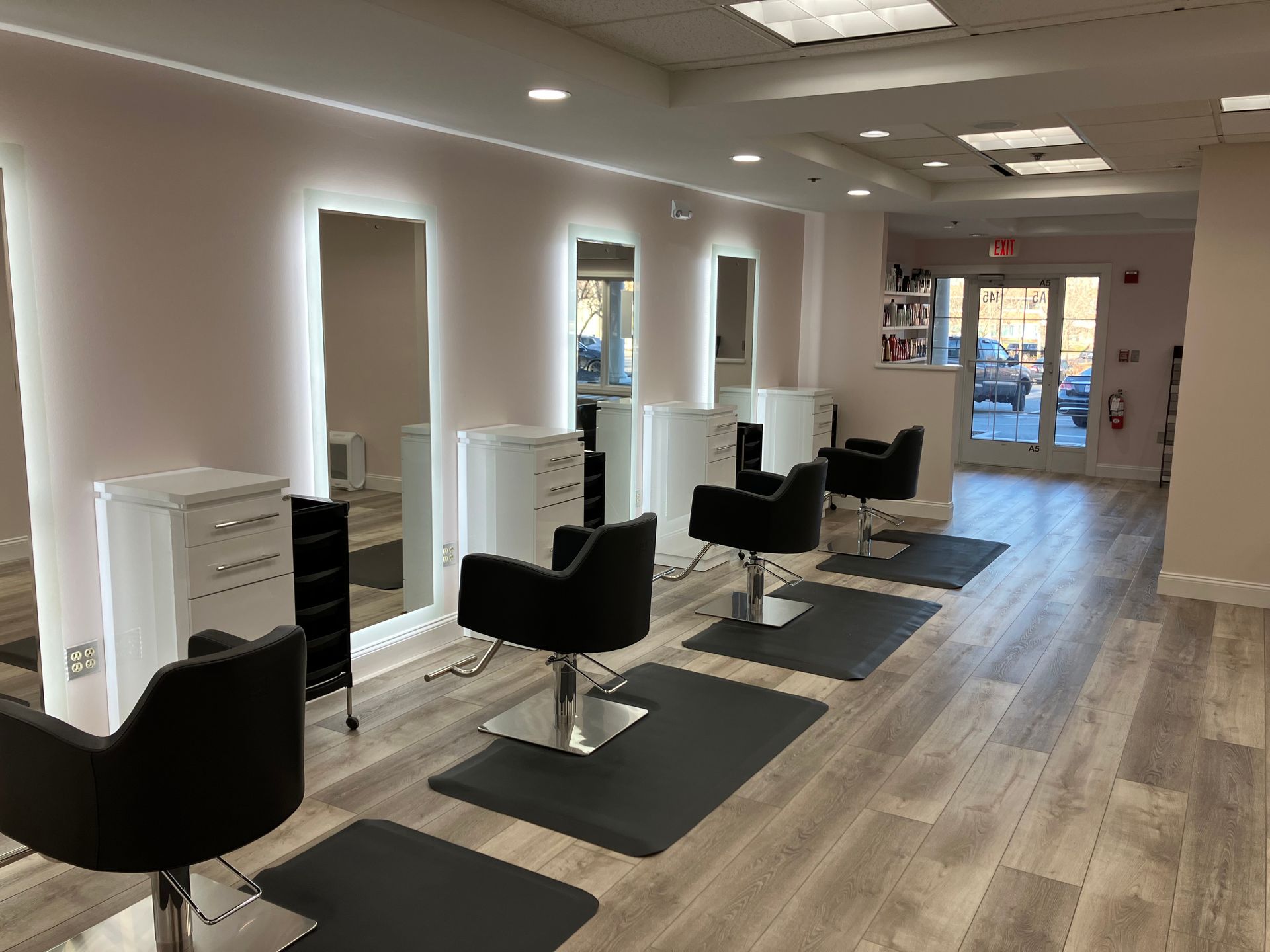 A hair salon with a lot of chairs and mirrors.