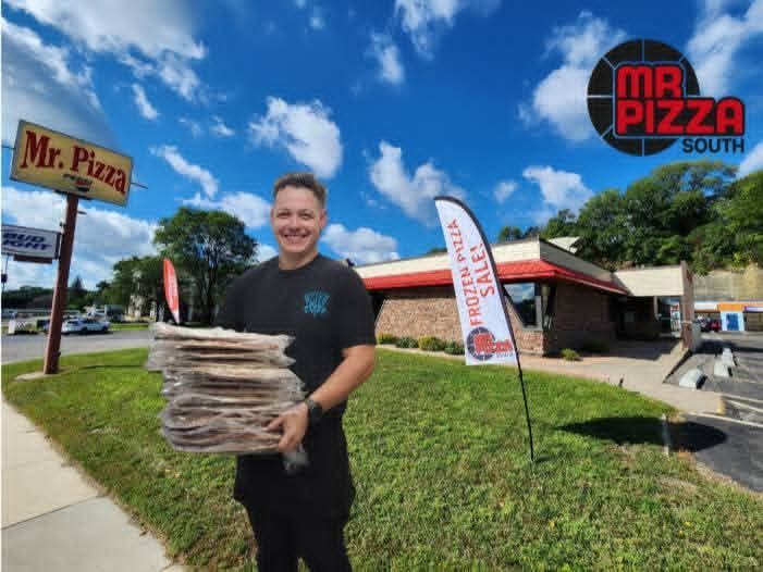 Man holding a stack of pizzas outside Mr. Pizza South on a sunny day