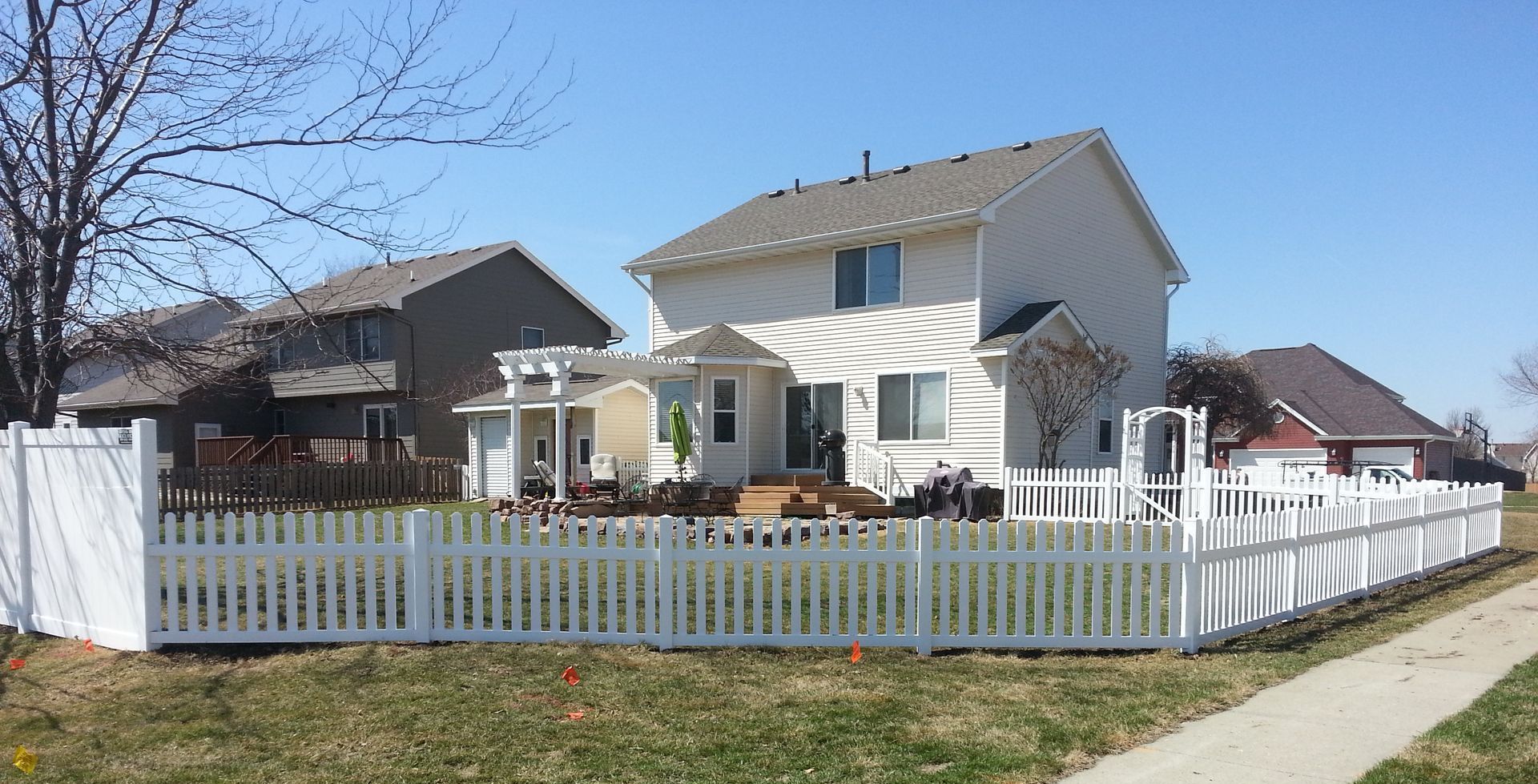 A house with a white picket fence in front of it