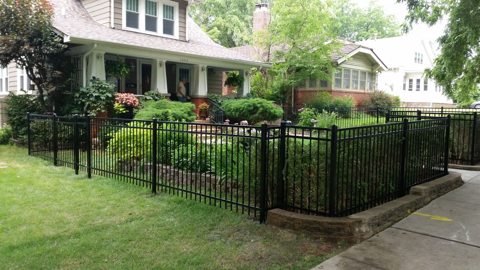 A house with a black fence in front of it.