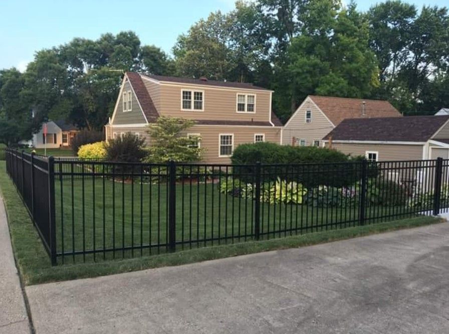 A house with a black fence in front of it