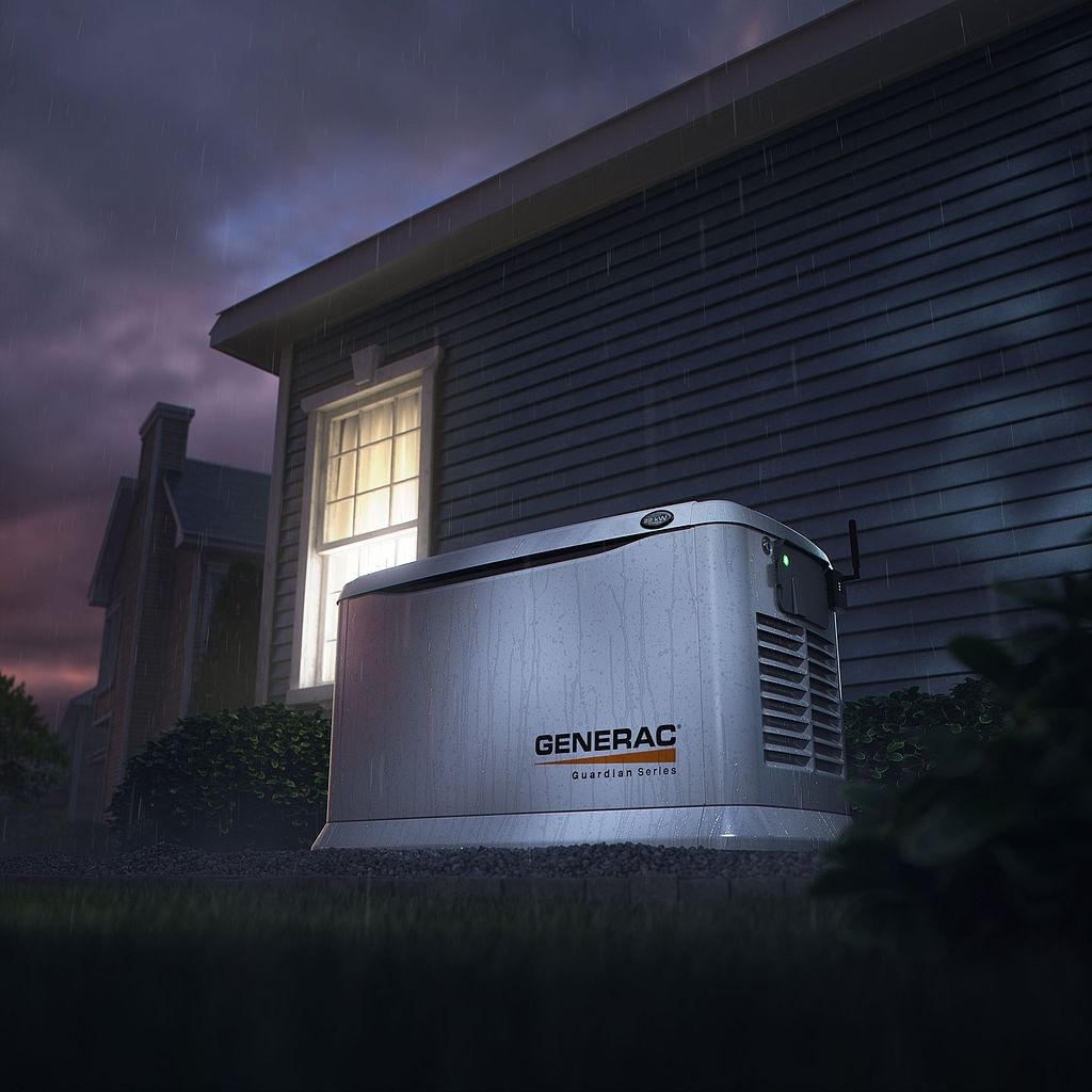 Generac backup generator beside a house at night, with a lit window and stormy sky