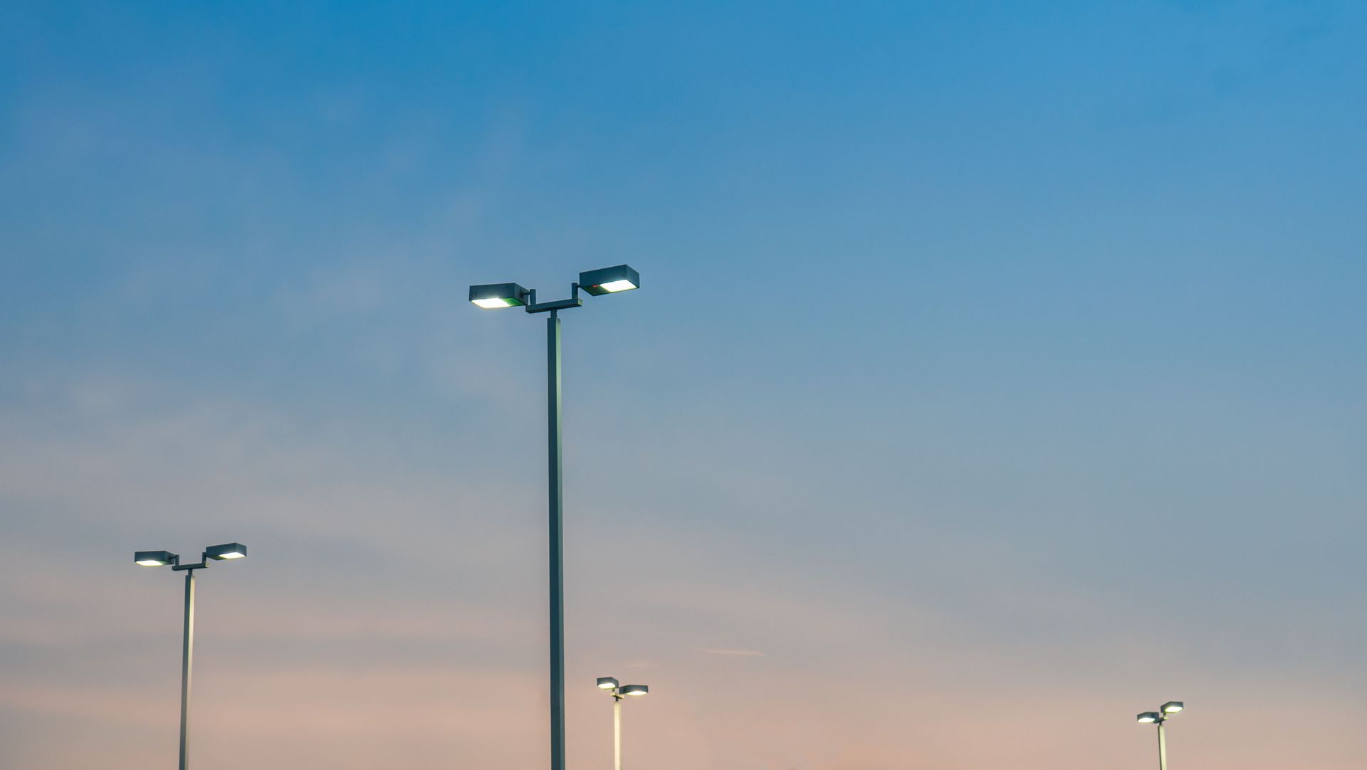 Streetlights against a pastel dusk sky.