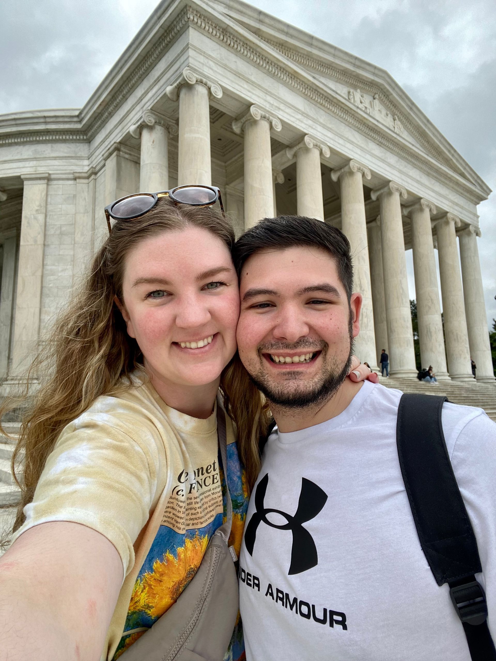 Selfie of two smiling people in front of the U.S. Supreme Court building