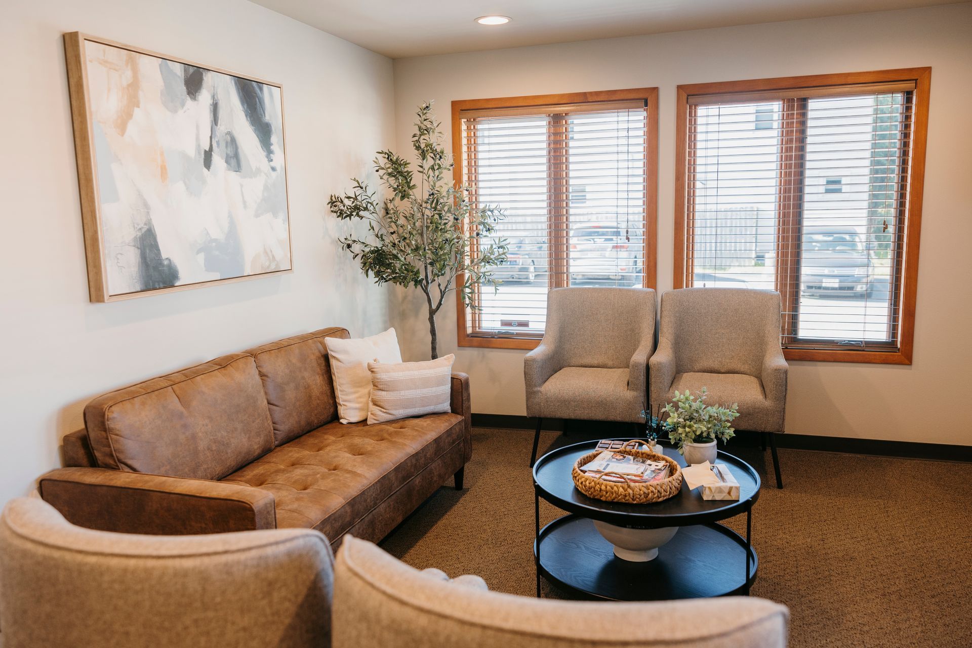 A living room with a couch , chairs , and a coffee table.