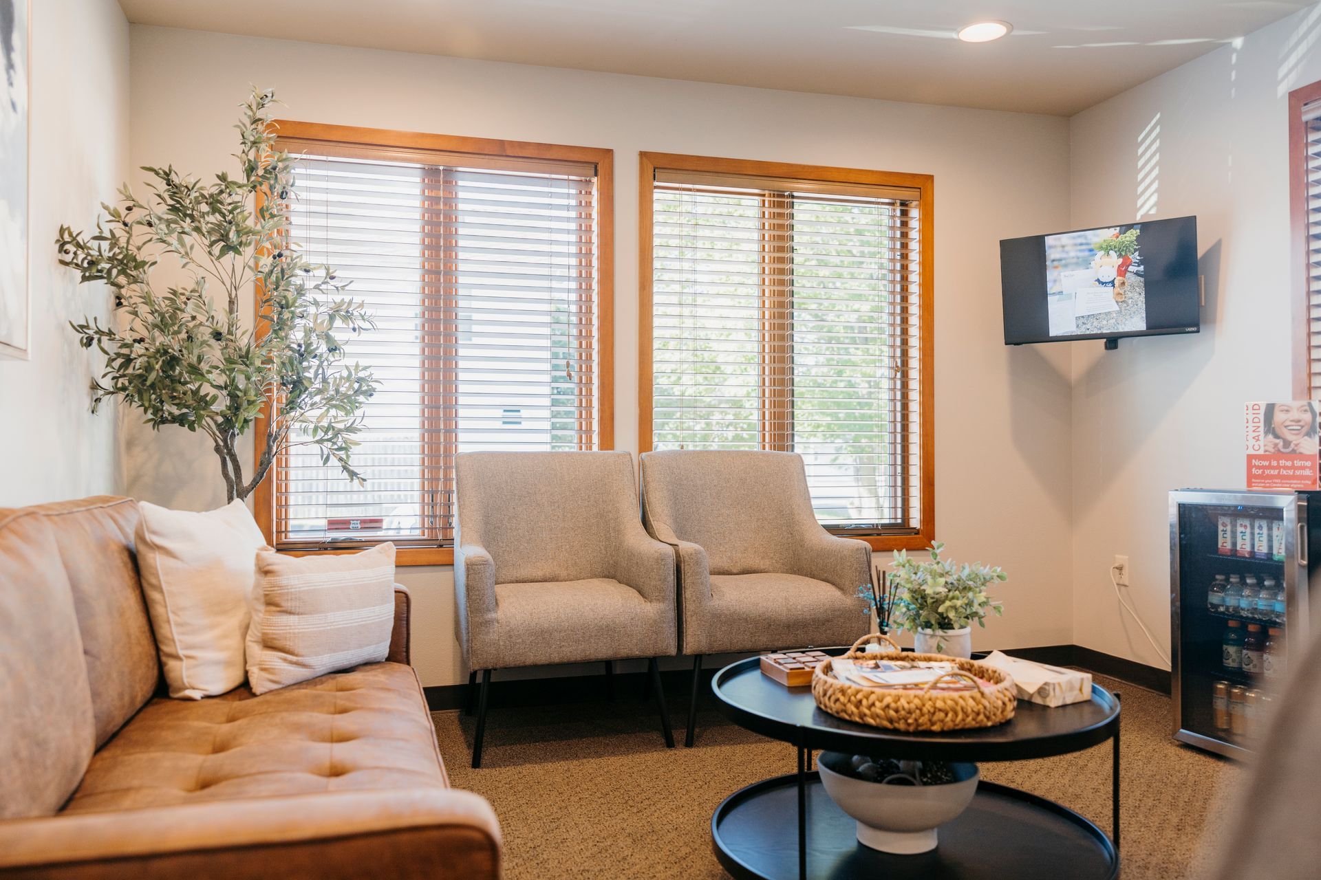 A living room with a couch , chairs , and a coffee table.