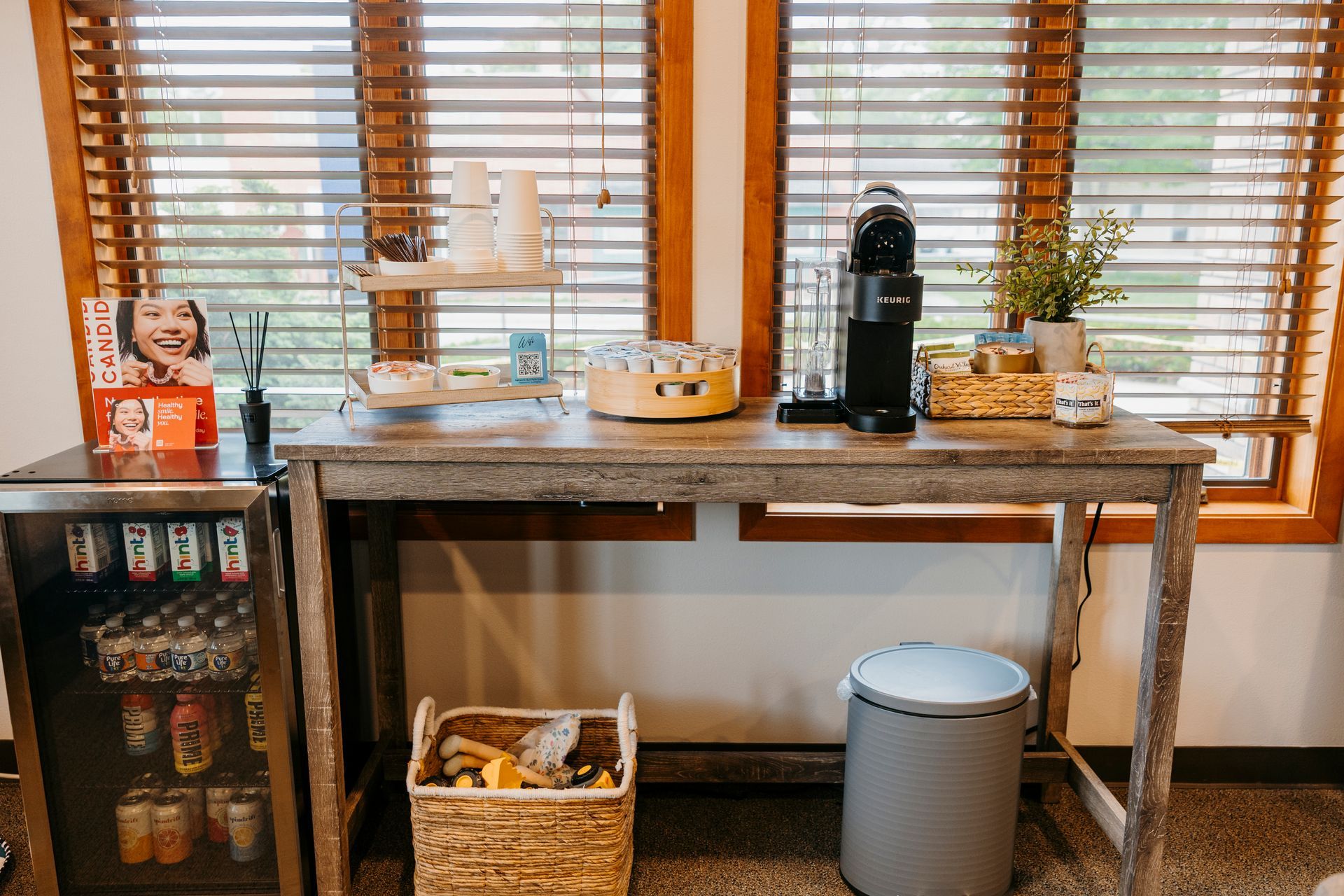 There is a table with a coffee maker on it in the room.