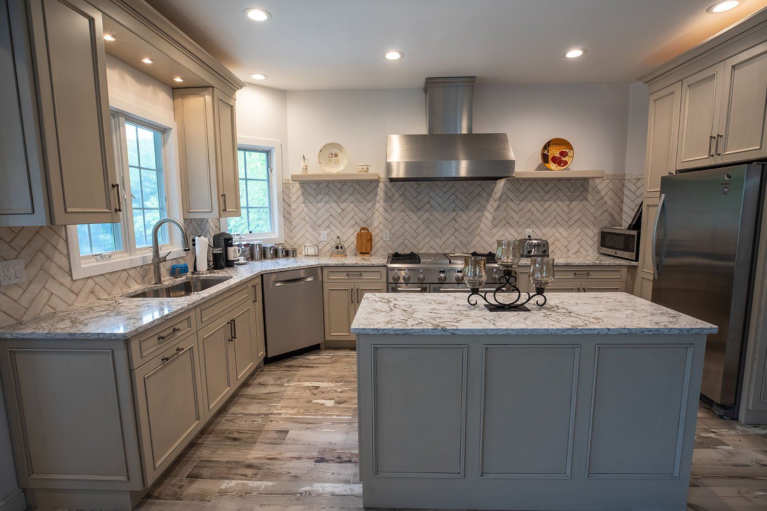 A kitchen with stainless steel appliances , granite counter tops , and a large island.