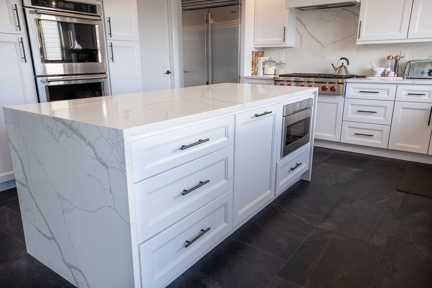 There is a large island in the middle of the kitchen.