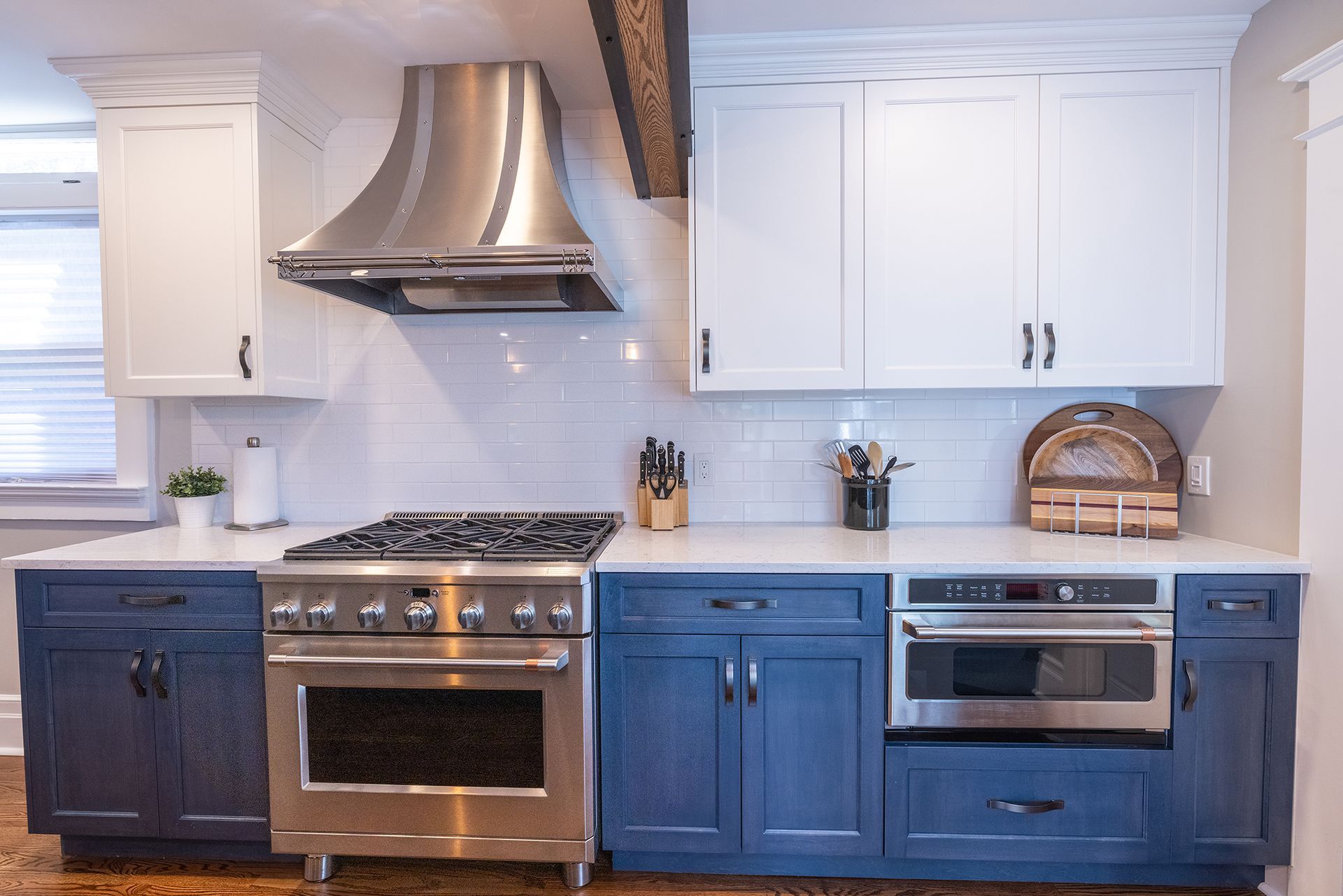 A kitchen with blue cabinets and stainless steel appliances