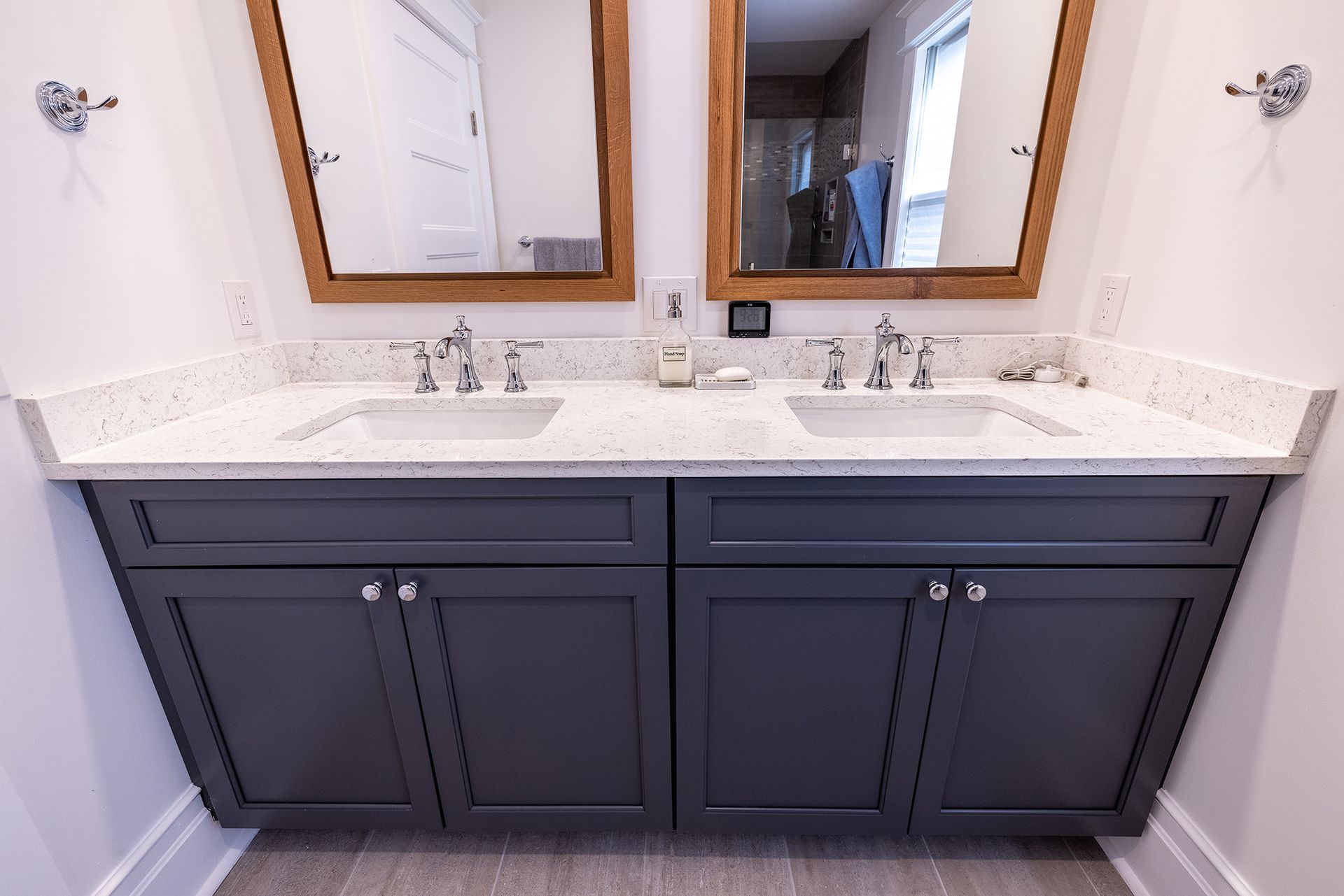 A bathroom with two sinks and two mirrors.