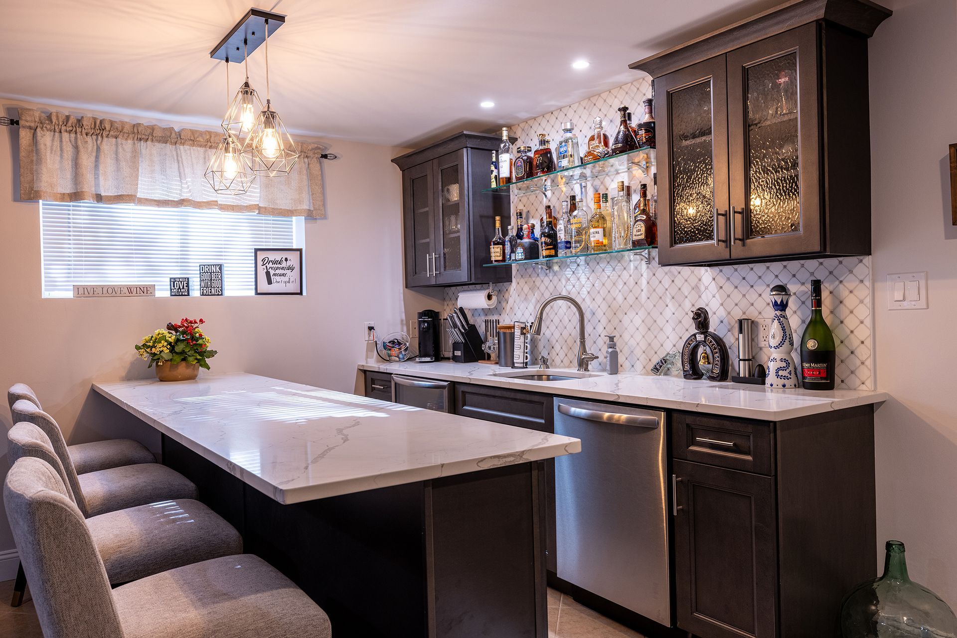 A kitchen with a large island and a bar.