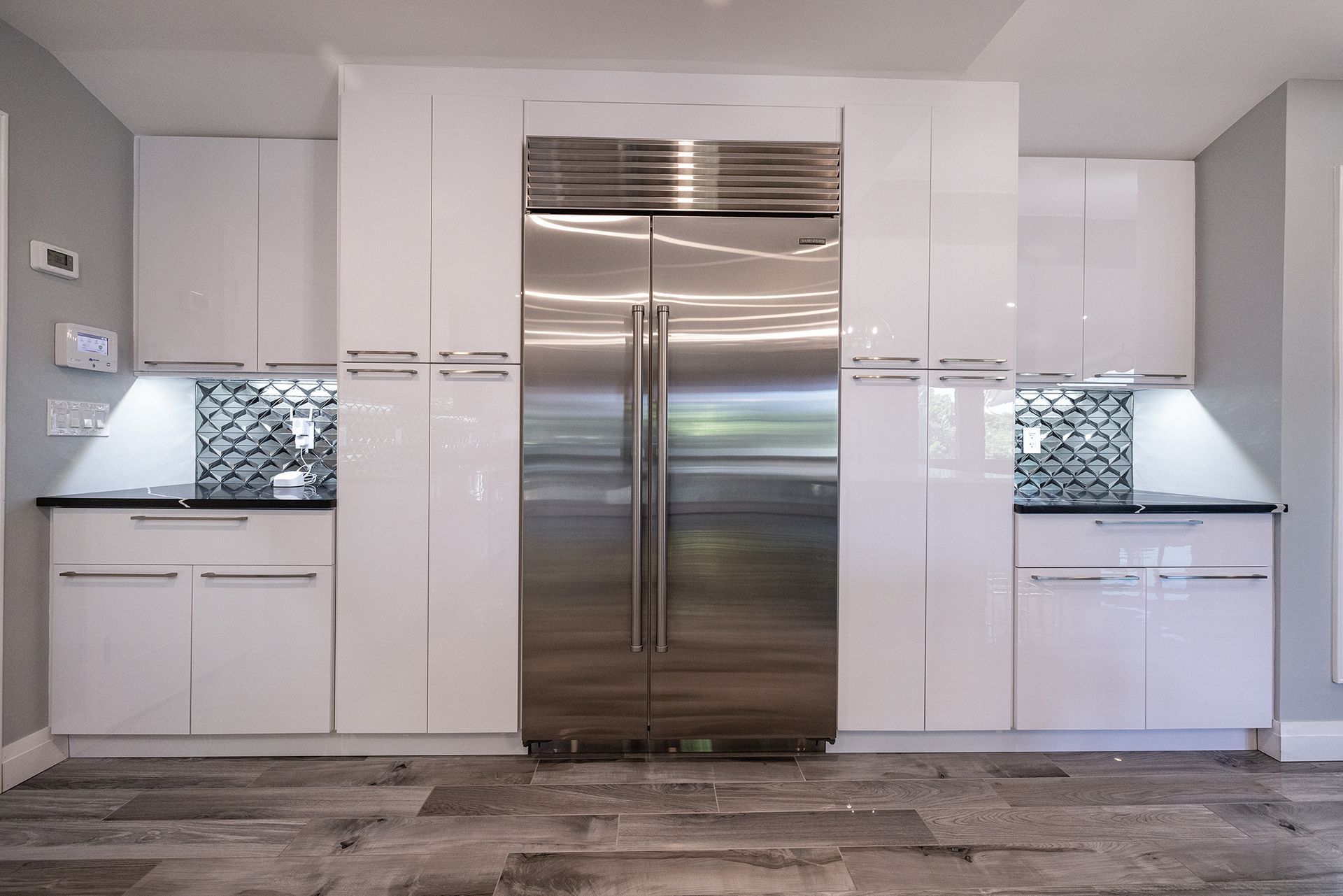 A kitchen with stainless steel appliances and white cabinets