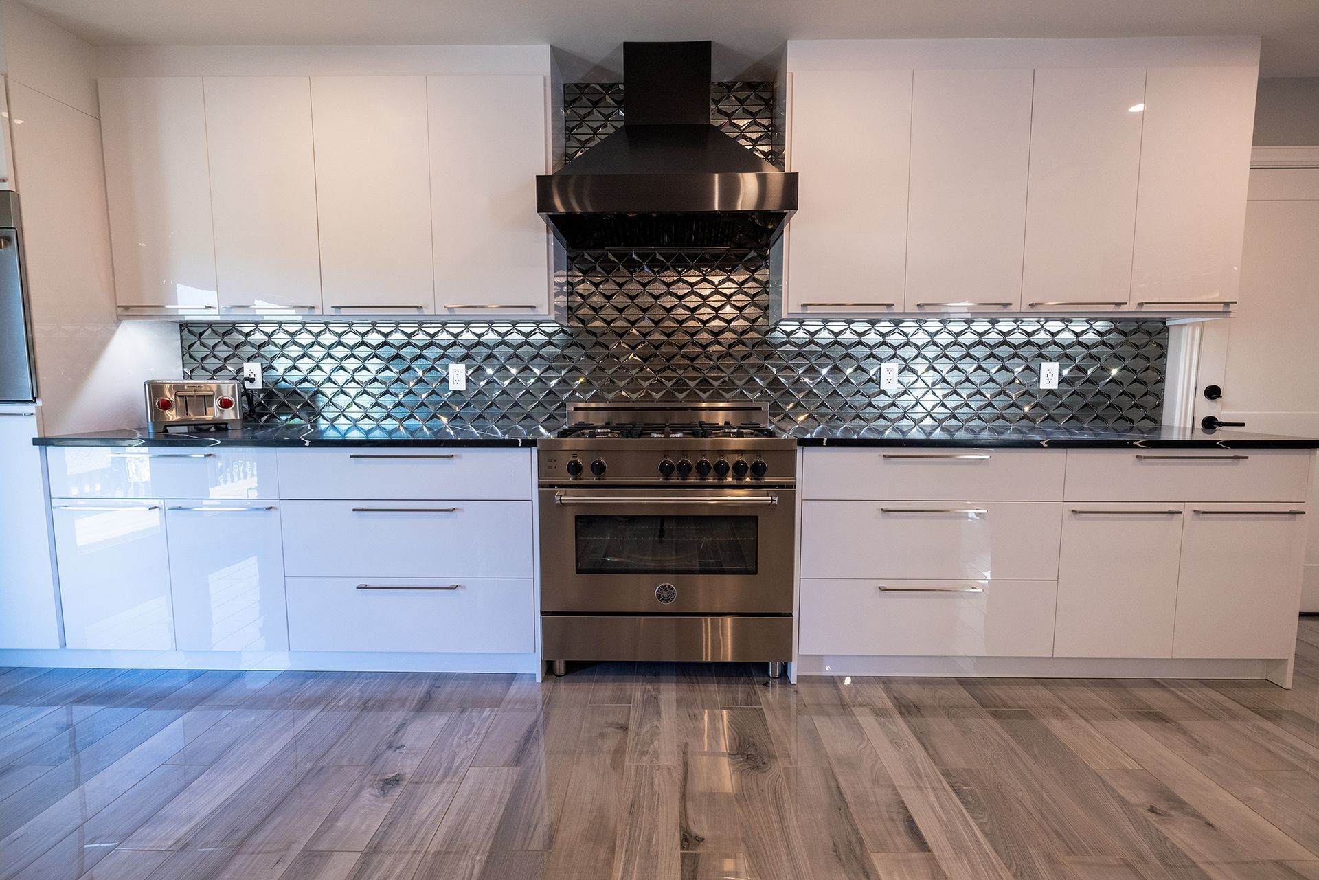 A kitchen with white cabinets and stainless steel appliances.