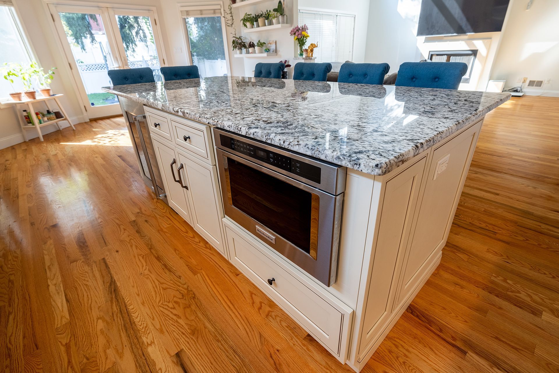 A kitchen with a large island and a microwave oven.