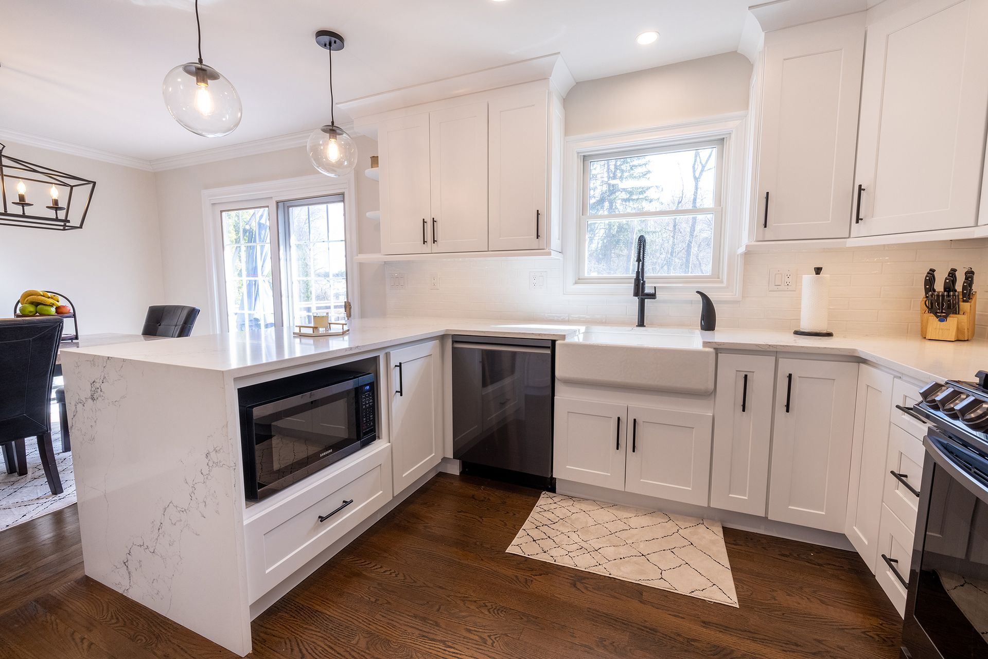 A kitchen with white cabinets and stainless steel appliances.