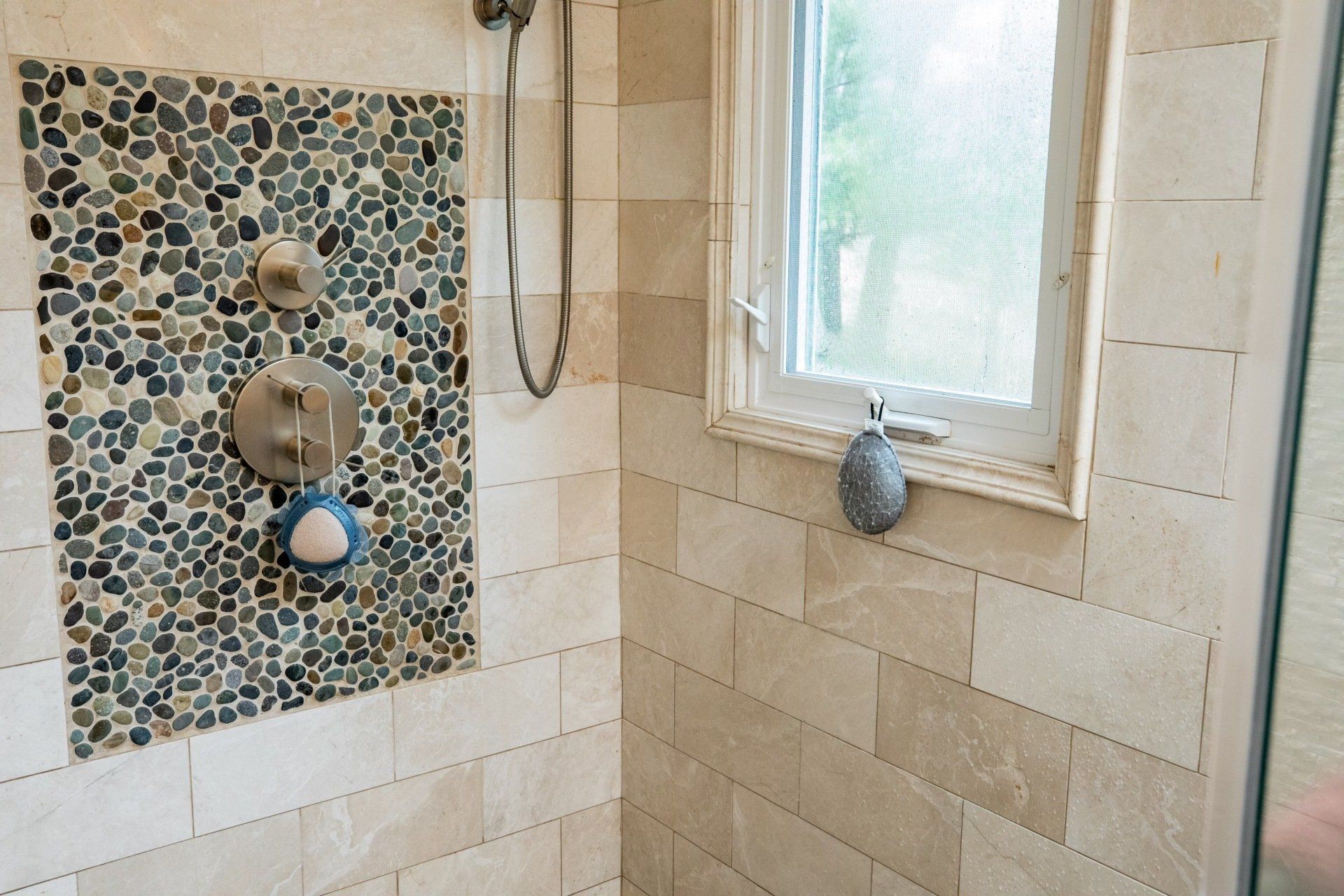 A bathroom with a shower and a window