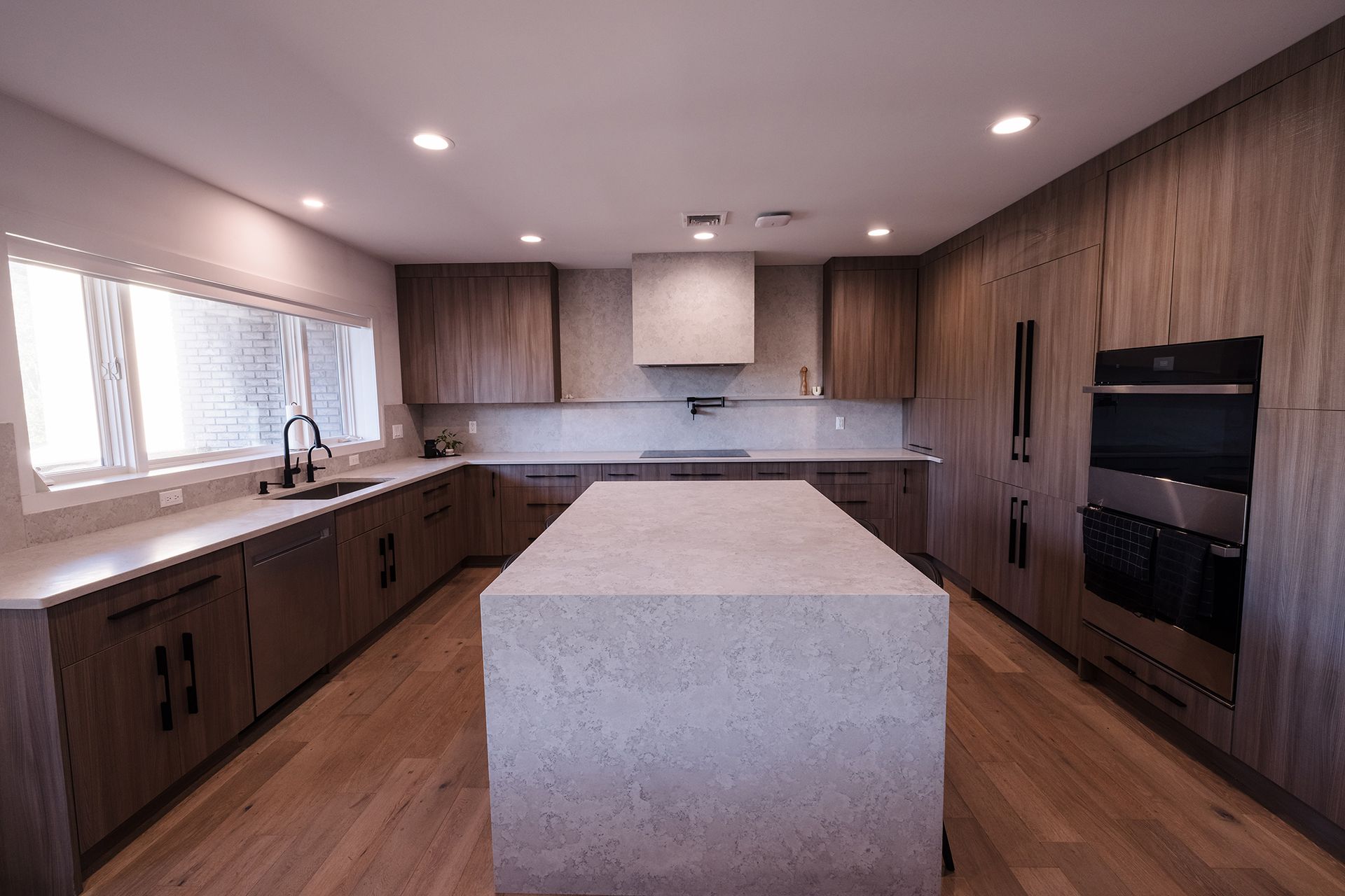 There is a large island in the middle of the kitchen.