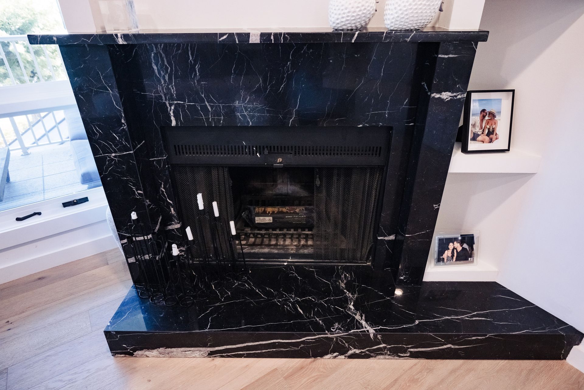 A black marble fireplace in a living room
