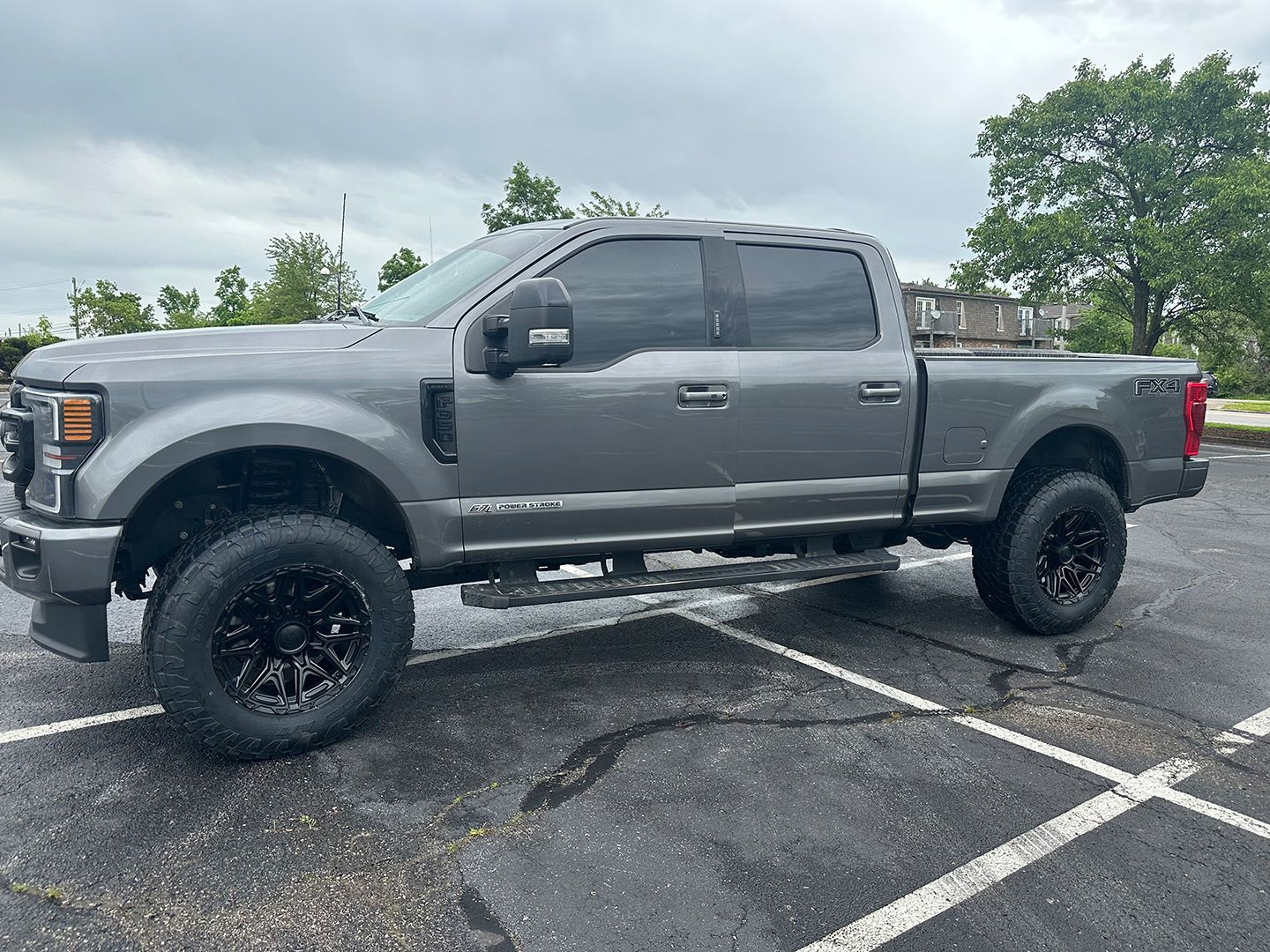 A gray pickup truck is parked in a parking lot.