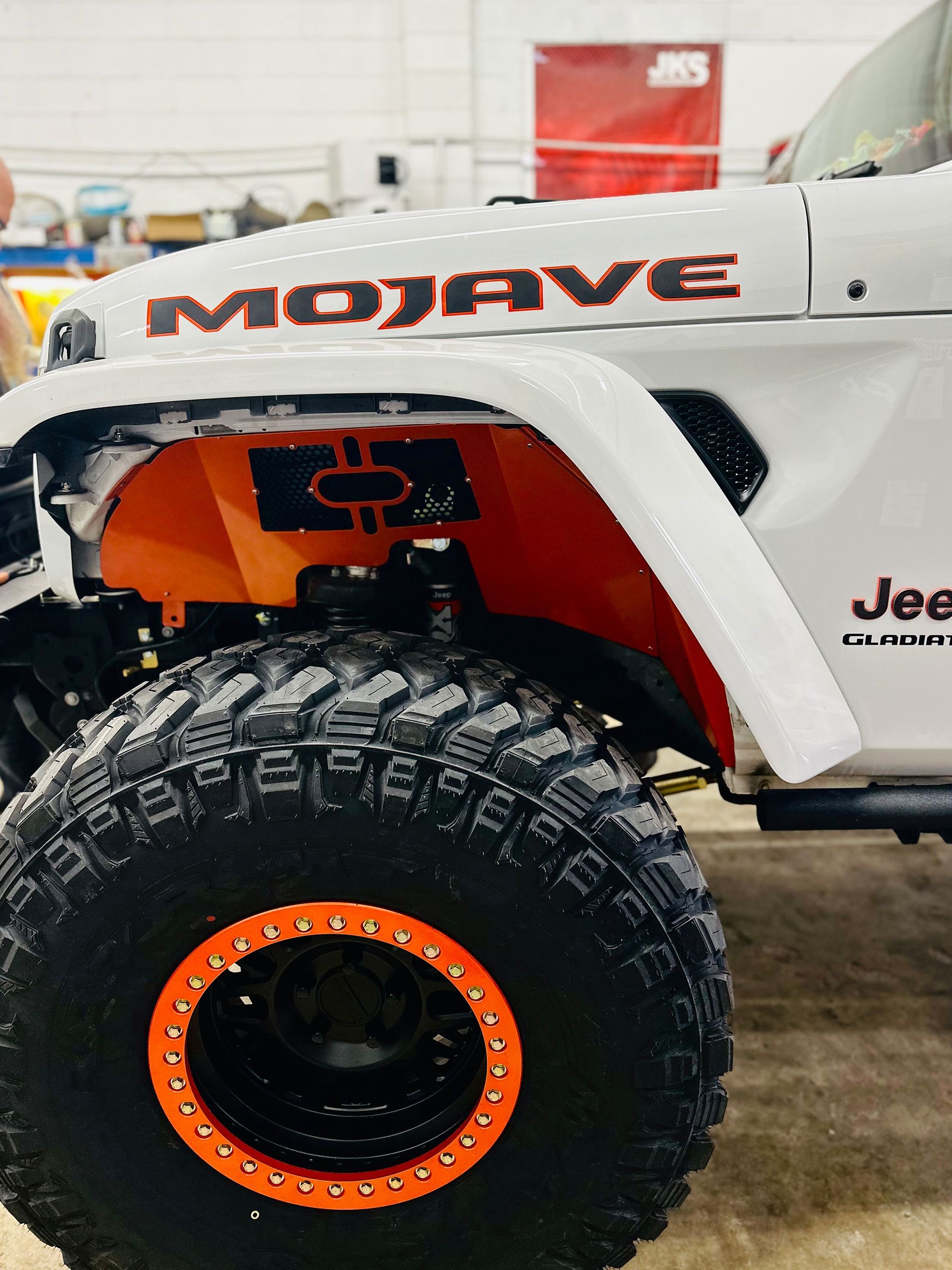 A white Jeep with the word Mojave on the hood