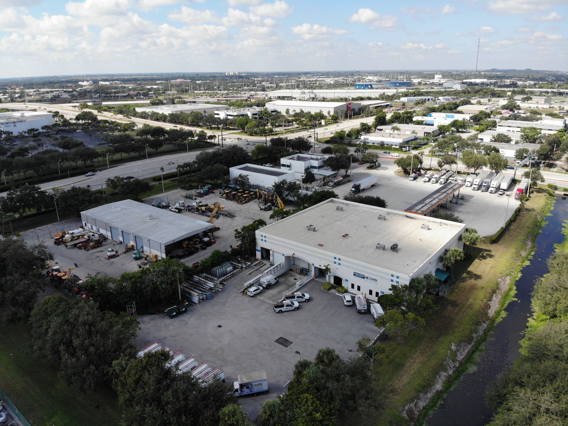 An aerial view of a large industrial area with lots of buildings and trees.