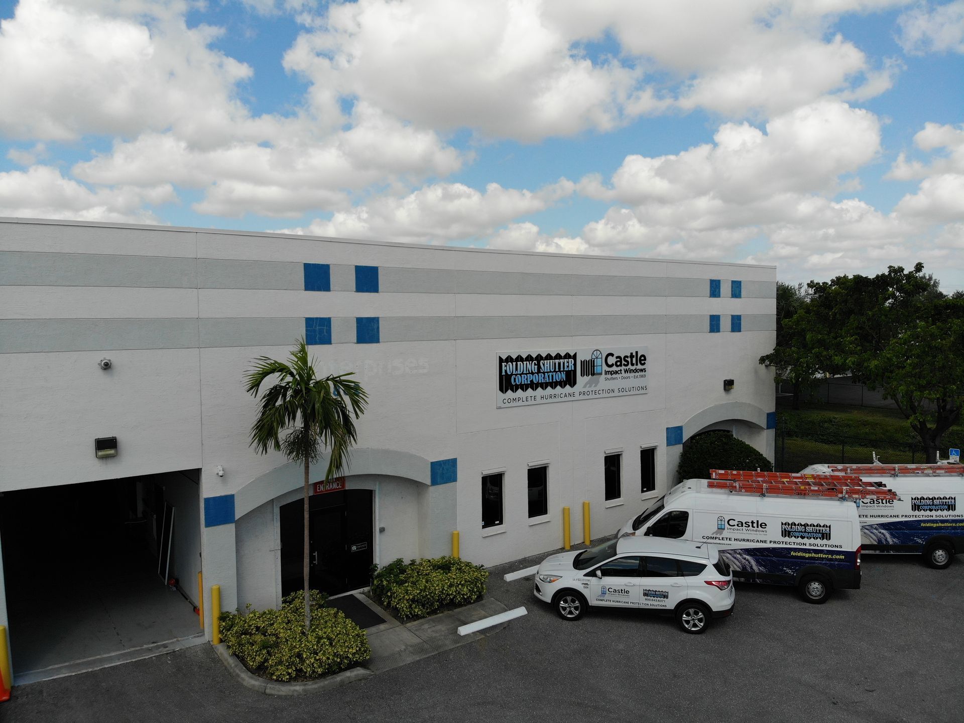 An aerial view of a building with cars parked in front of it