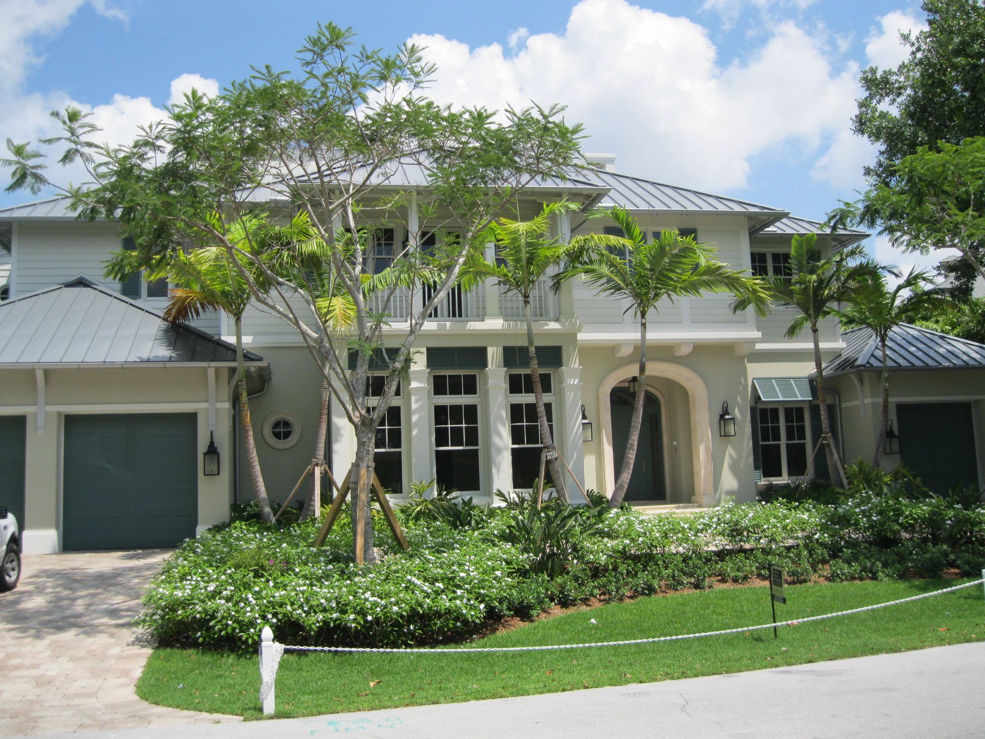 A large white house with a metal roof