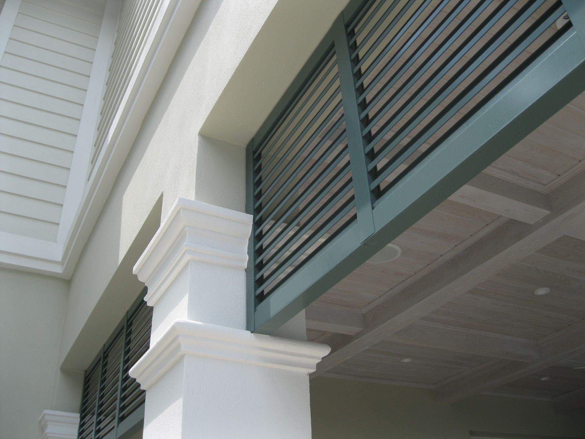 A building with white columns and shutters on the windows