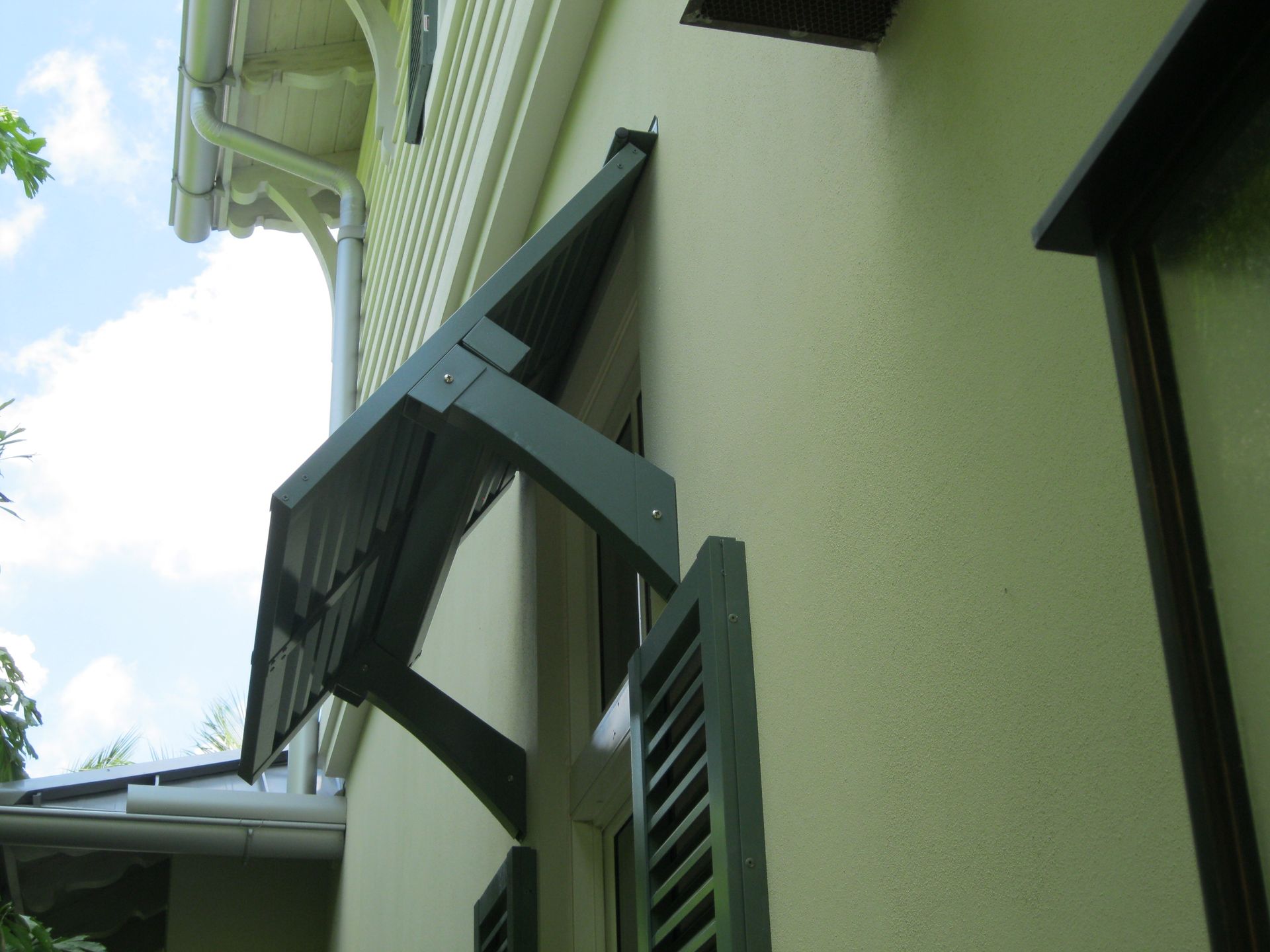 A house with a window with a canopy over it