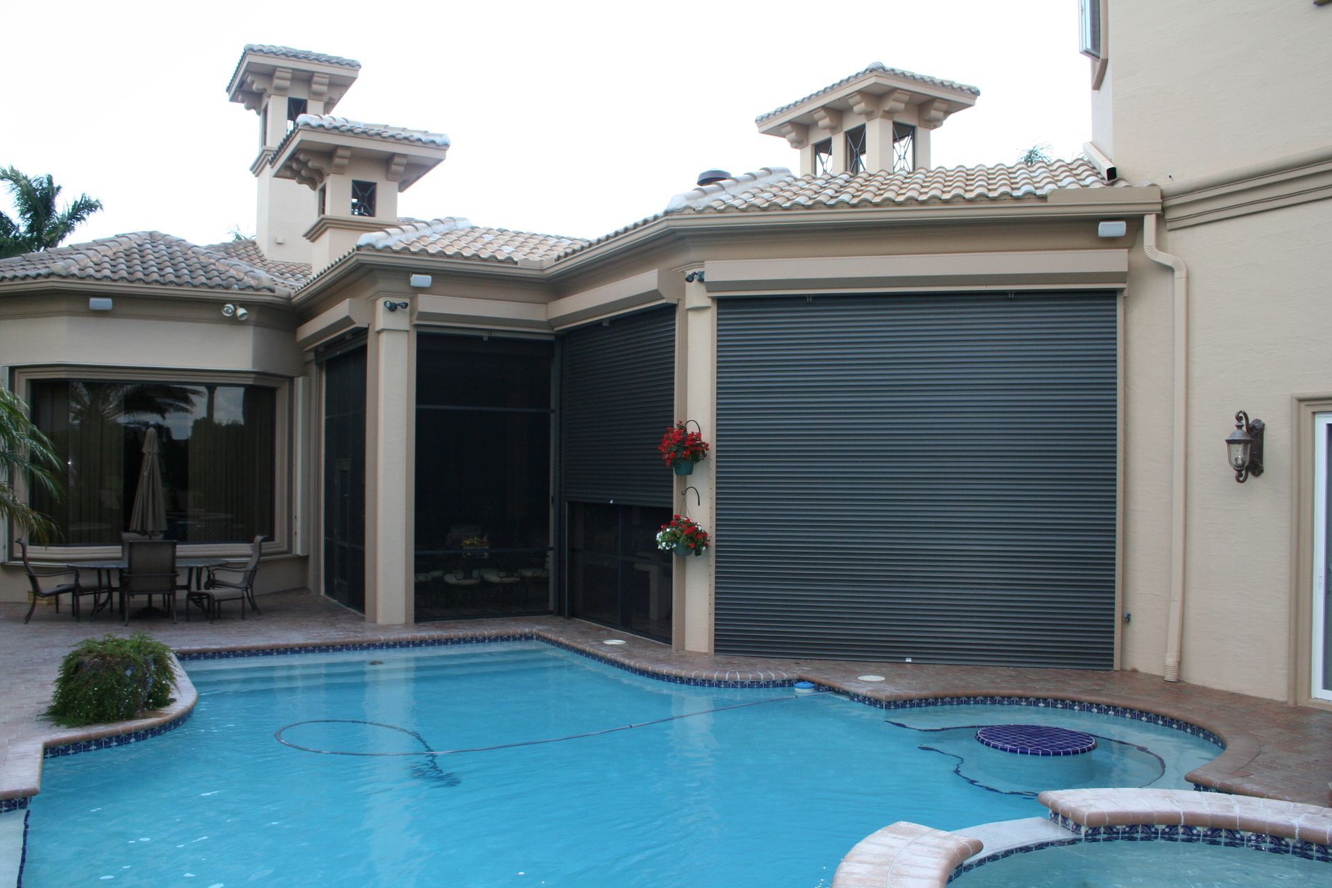 A large house with a swimming pool in front of it