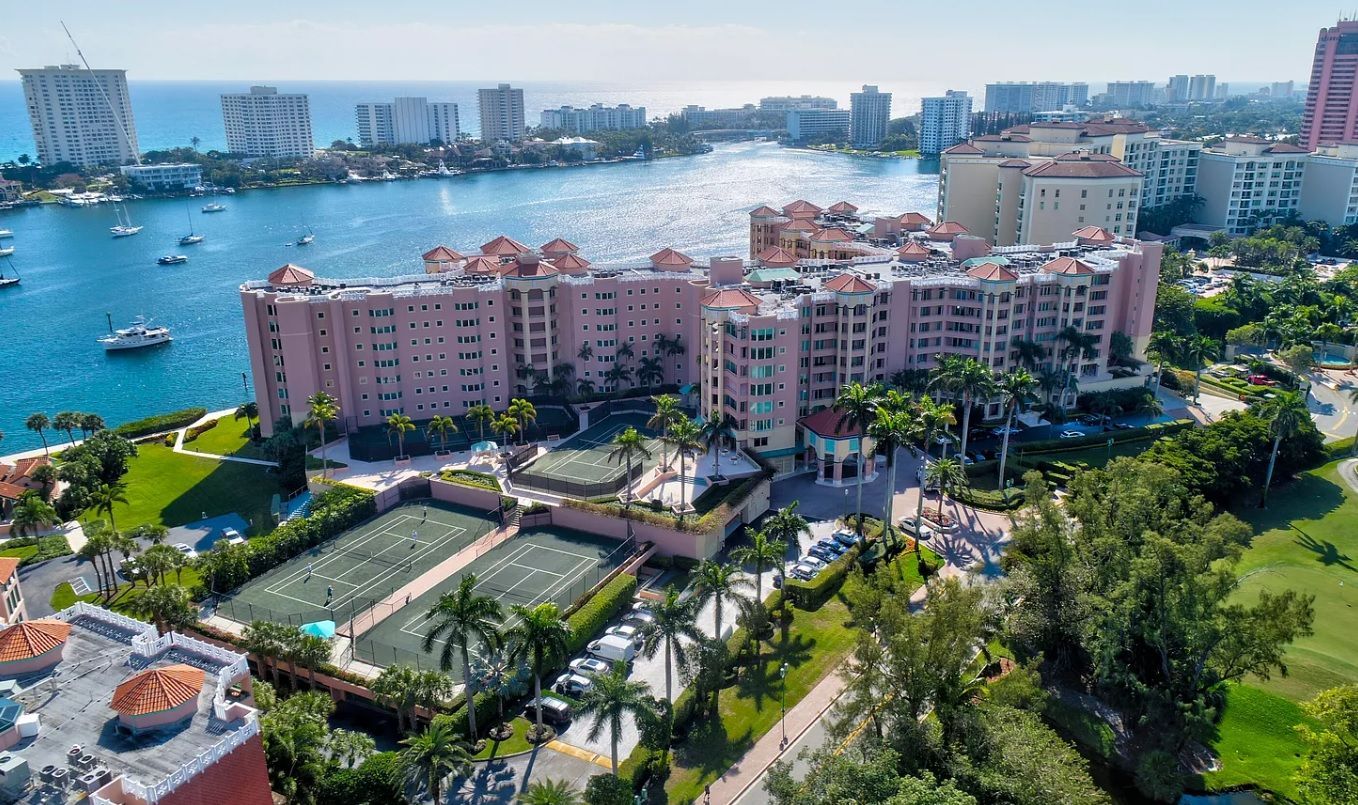 An aerial view of a large building next to a body of water.