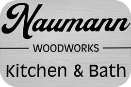 Logo for Naumann Woodworks Kitchen & Bath with black text on a light gray wood-grain background.