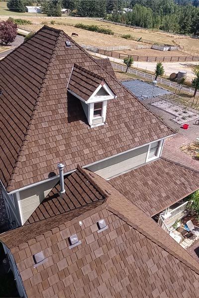 An aerial view of a house with a brown roof.