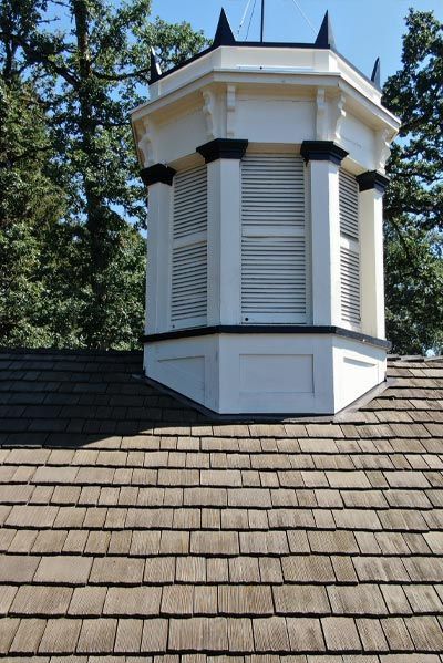 A wooden roof with a white building on top of it
