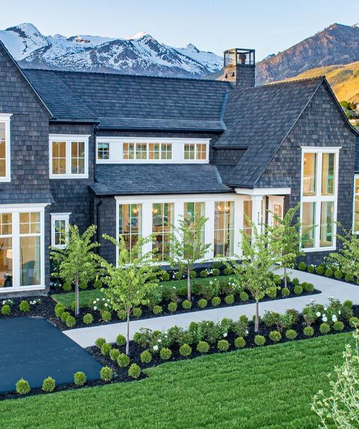 A large house with a lot of windows and trees in front of it