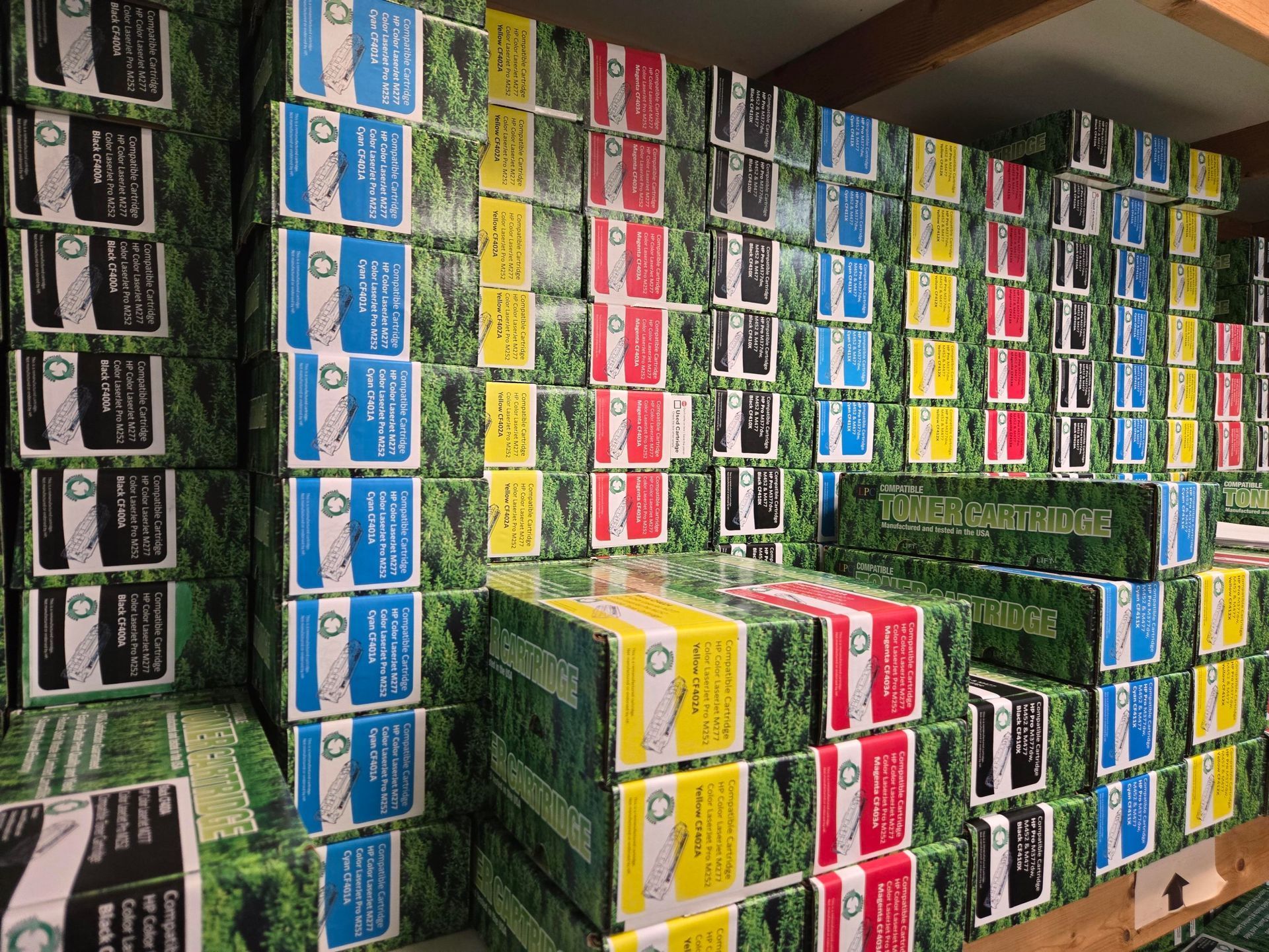 Stacks of colorful printer ink boxes, arranged on shelves.