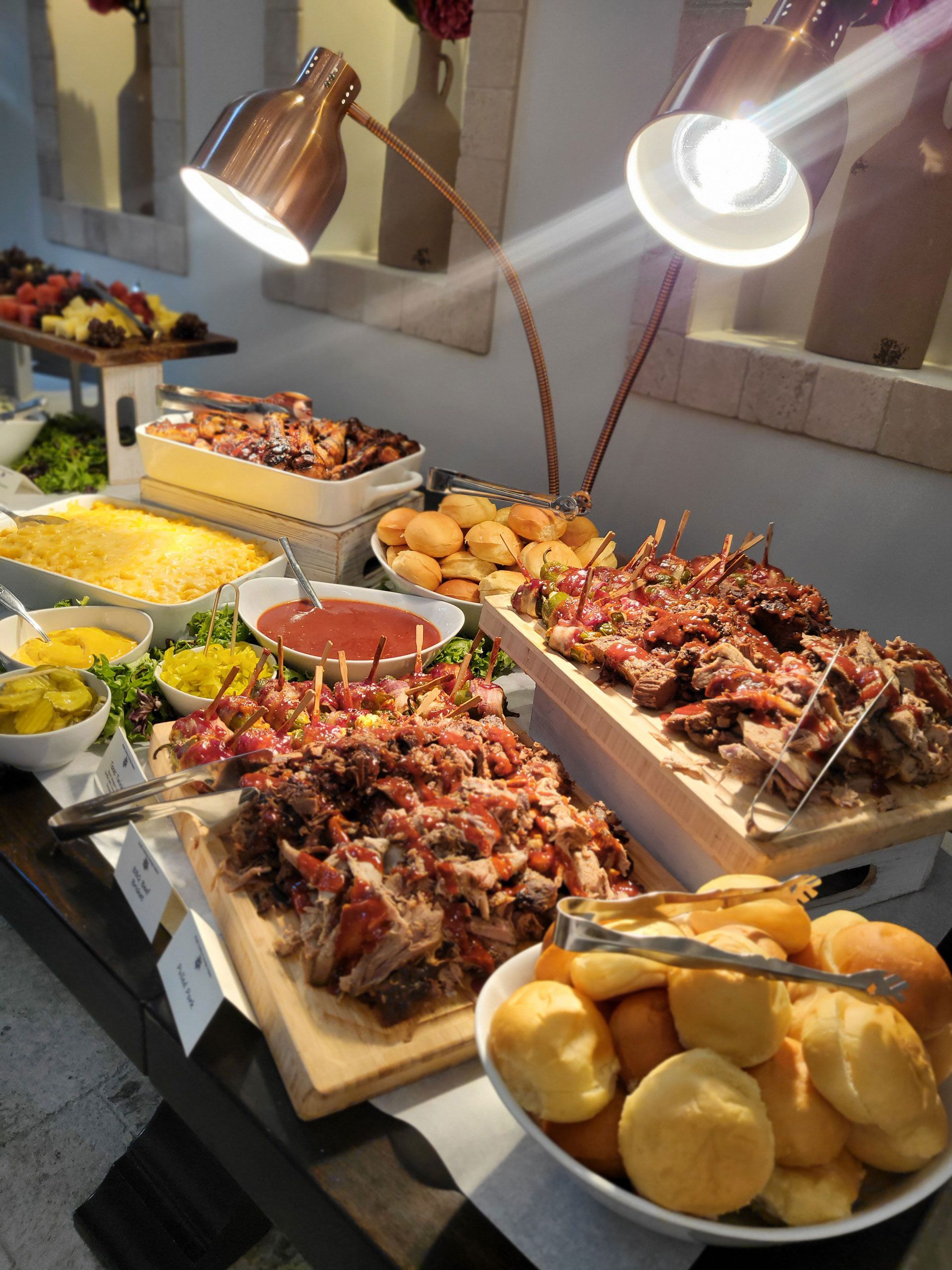 A buffet table with different types of BBQ on it